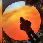 Silhouette of a person in front of a glowing sunset circle, used as a testimonial avatar