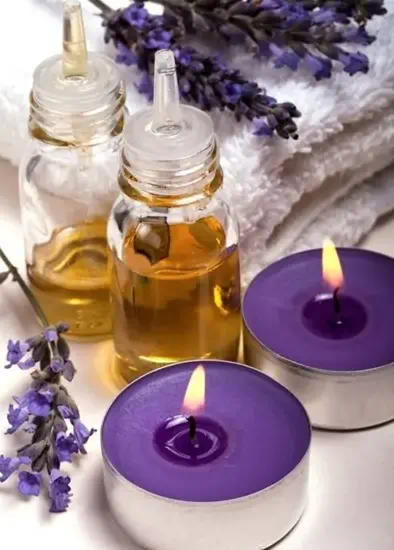 lavender-massage-oil-candles Lavender aromatherapy oils and purple massage candles for relaxing spa sessions